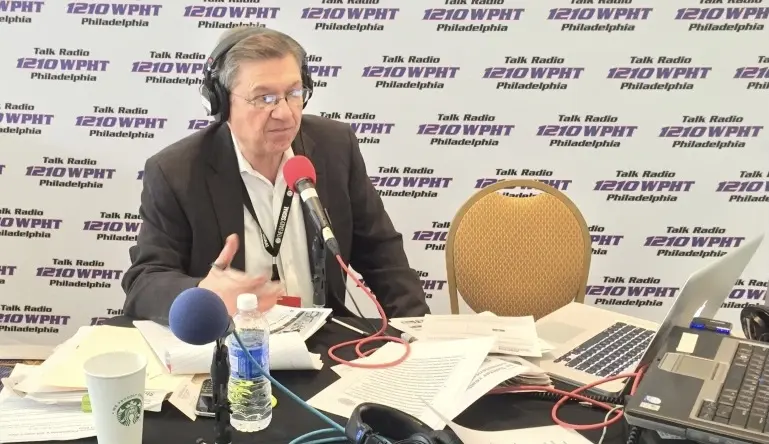 Dom Giordano broadcasting live behind a WPHT microphone